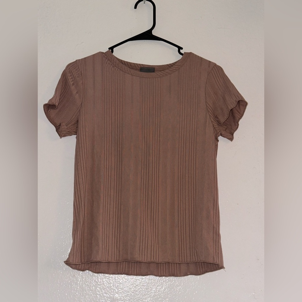 Beautiful shirt. Size is medium but also fits a small. Brand is Olivia Rea.